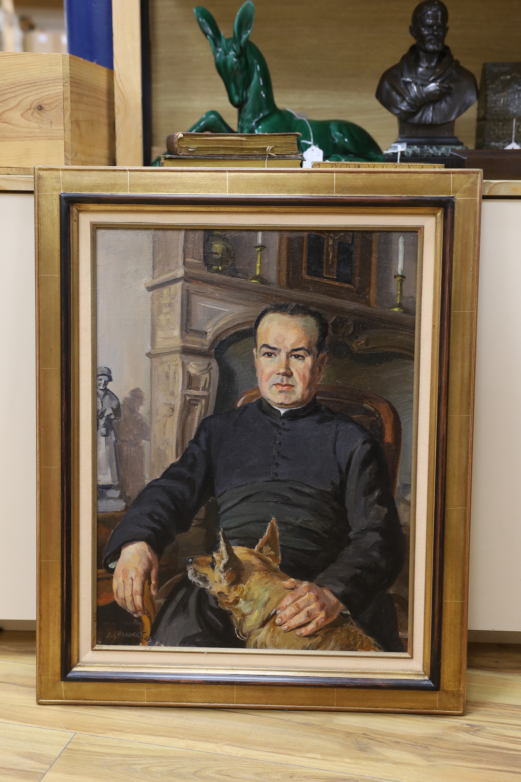 Ernest Chanonat (French, 1907-1995), oil on canvas, Portrait of a curate seated with his dog, signed with presentation inscription and dated '43, 60 x 45cm